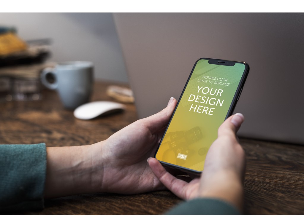 user-holding-smartphone-mockup-psd